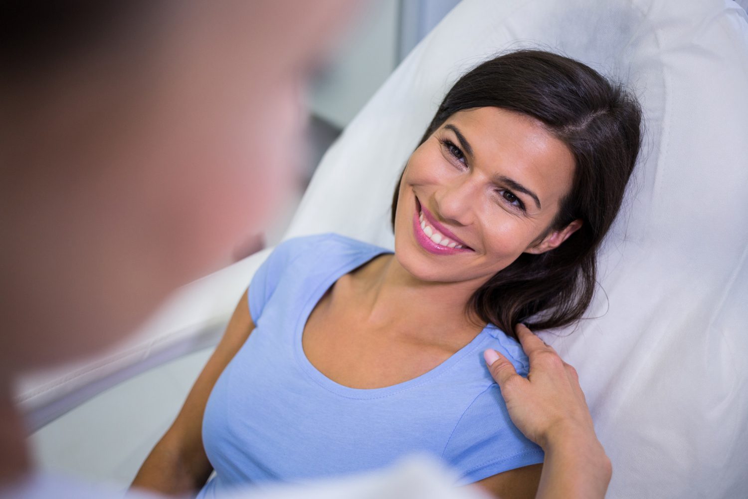 A smiling patient at Evora Health & Wellness